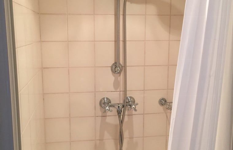Shower in the bathroom of Holiday Home in Epen, South Limburg, with classic tiles.