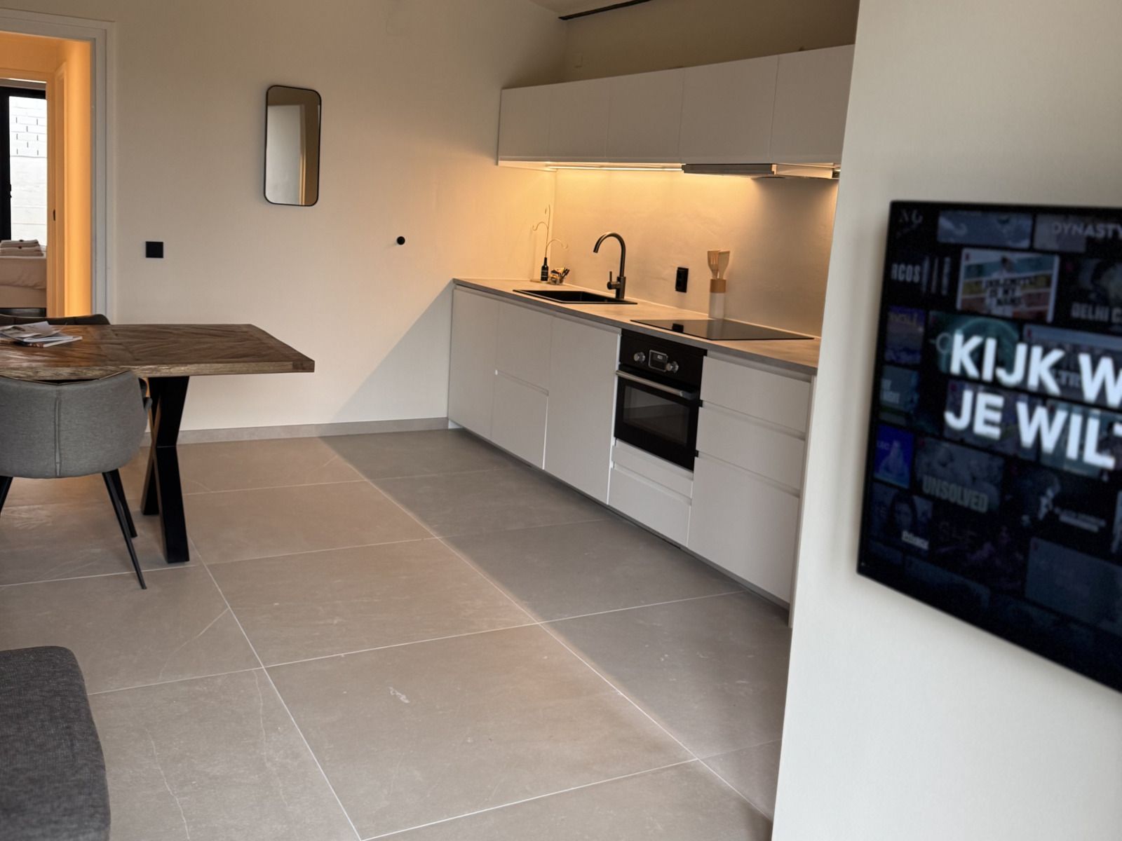 Entspannender Innenbereich des Ferienhauses L329 in Epen, Suedlimburg, mit modernem TV und Blick auf die Terrasse.