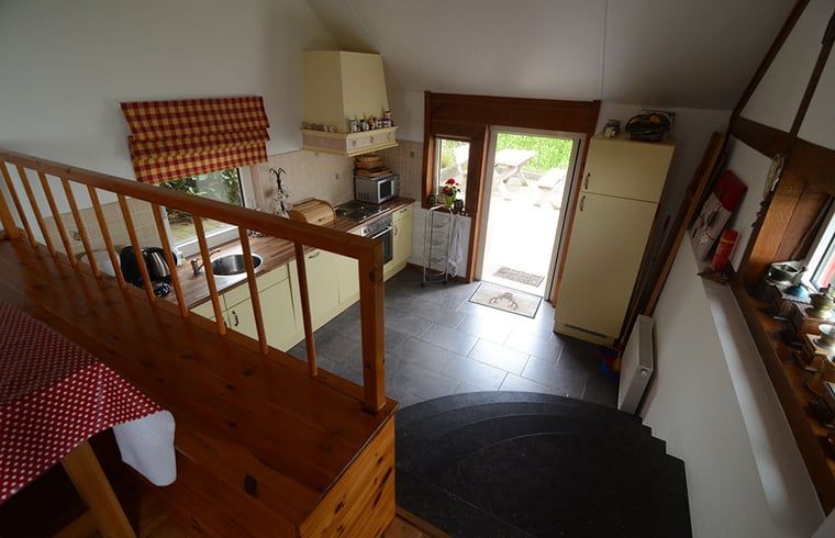 Kitchen overlooking terrace in cottage in Vijlen, South Limburg, offers access to outdoor fun.