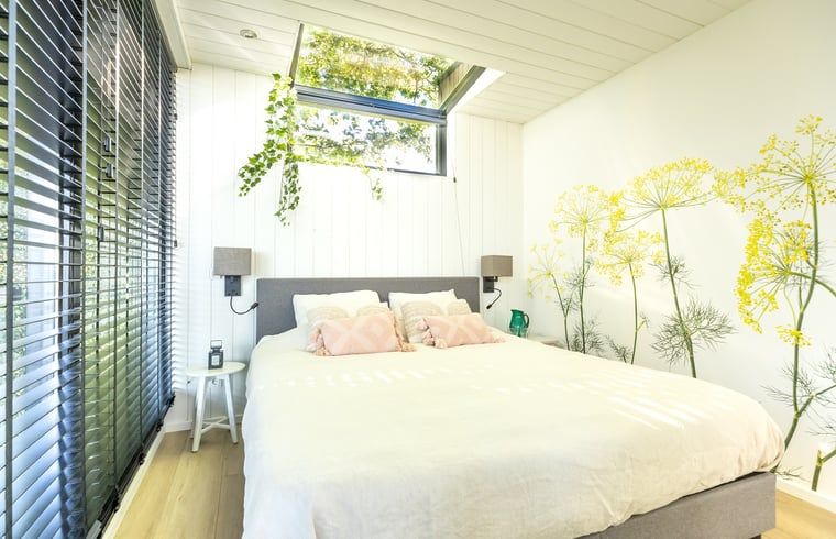 Spacious bedroom in Holiday Home in Mierlo, North Brabant, with decorative mural.