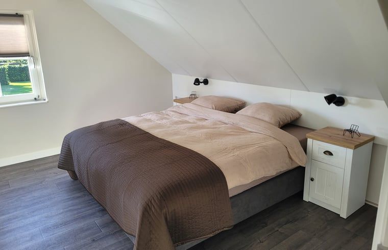 Bright dining area in Cottage in Zeeland overlooking the garden, ideal for a relaxing vacation in De Peel.