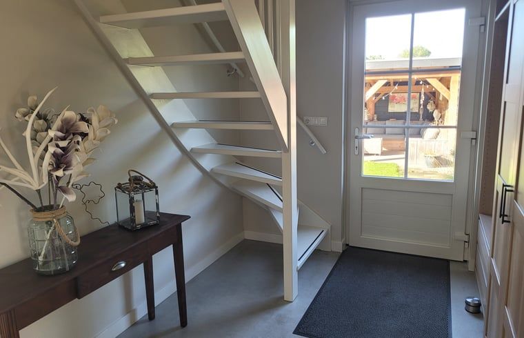 Comfortable bedroom with large bed in Cottage in Zeeland, ideal for a relaxing stay in De Peel.