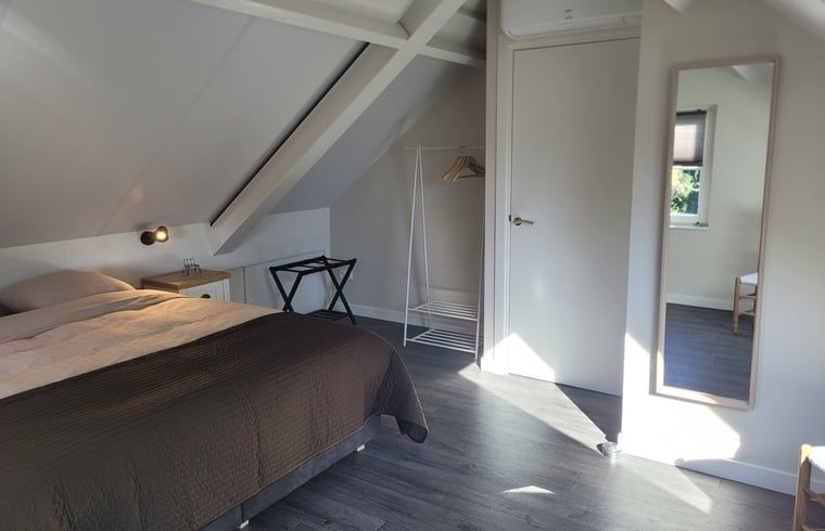 Rocking bench on the terrace of Cottage in Zeeland, a perfect place to enjoy nature in De Peel.