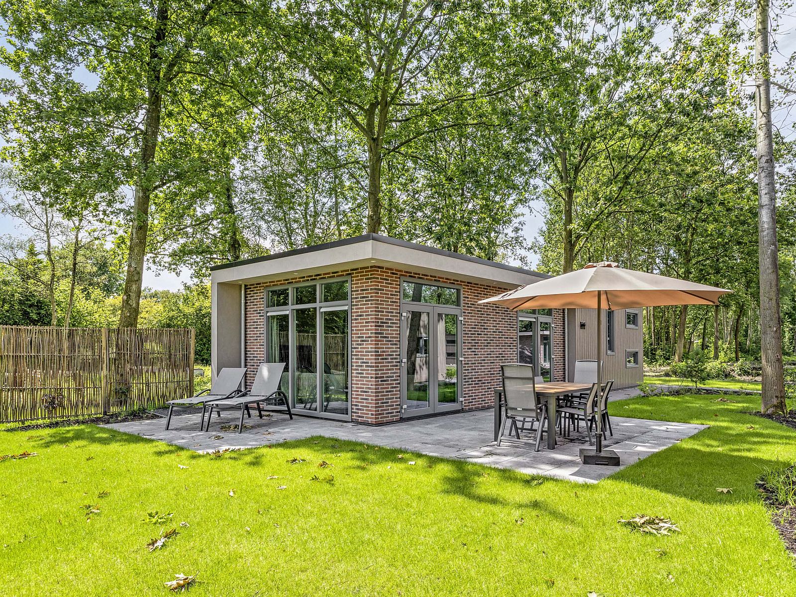 Berkenhof vacation home with hot tub in Lage Mierde, North Brabant, surrounded by green nature and a spacious terrace for relaxation.