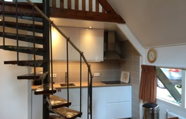 Modern kitchen in Holiday home in Eersel, North Brabant, with wooden staircase and cozy interior for a comfortable stay.