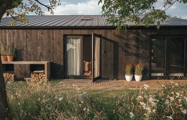 Charming entrance to Holiday home in Chaam, North Brabant with wooden facade and veranda in Heart of Brabant.