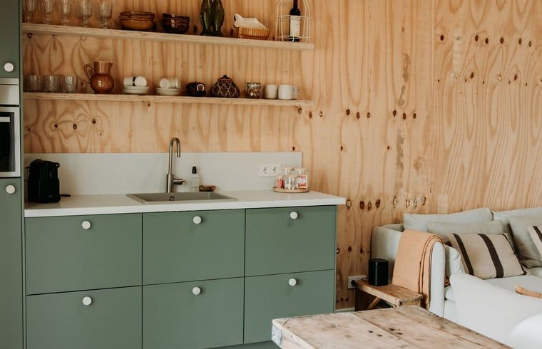Stylish kitchen in Holiday Home in Chaam, North Brabant with modern appliances and wooden accents.