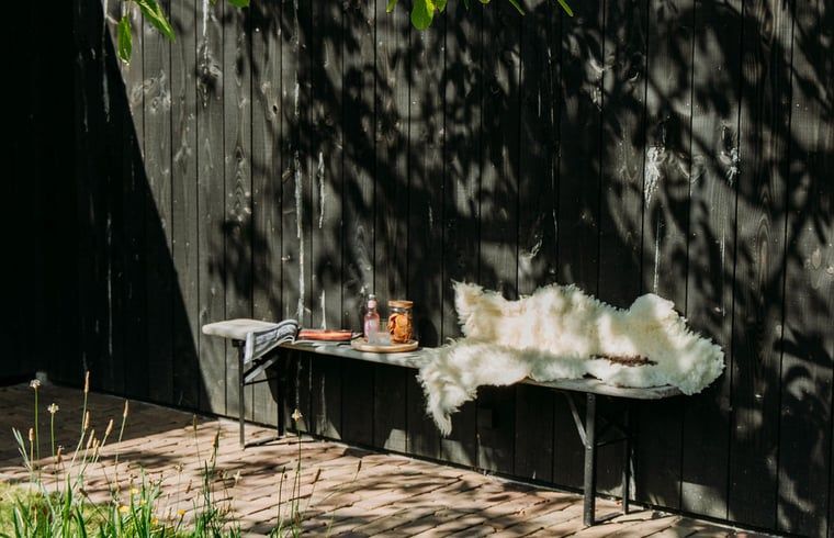 Shaded outdoor seating area Holiday home in Chaam, North Brabant, perfect for quiet afternoons.