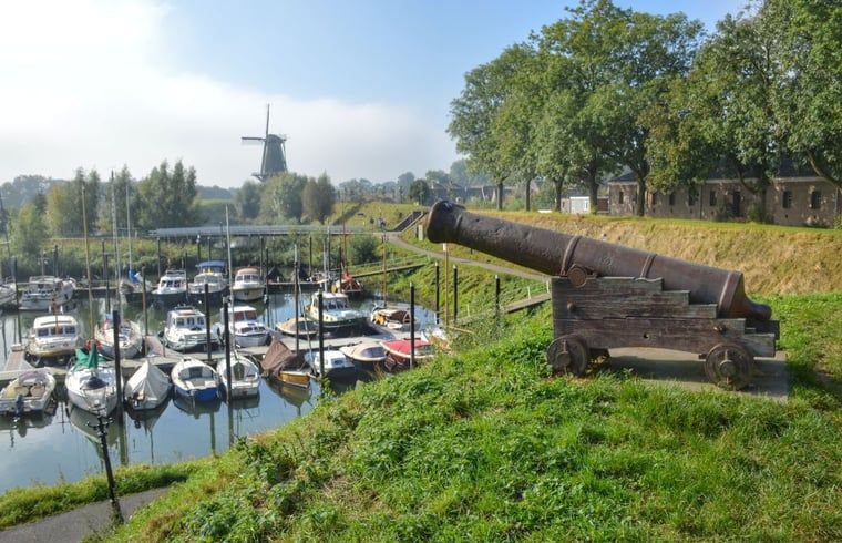 Historische Kanone mit Blick auf den Hafen bei Cottage in Woudrichem, Nordbrabant.