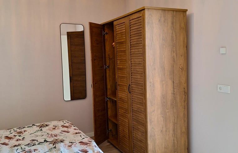 Wooden closet in bedroom of Huisje in De Moer, vacation home in North Brabant.