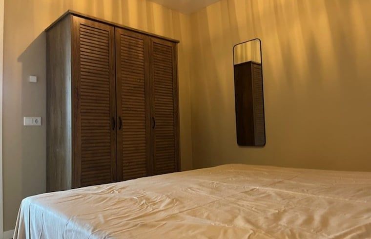 Schlafzimmer in Cottage in De Moer, Ferienhaus im Herzen von Brabant, mit rustikalem Schrank und warmer Einrichtung.