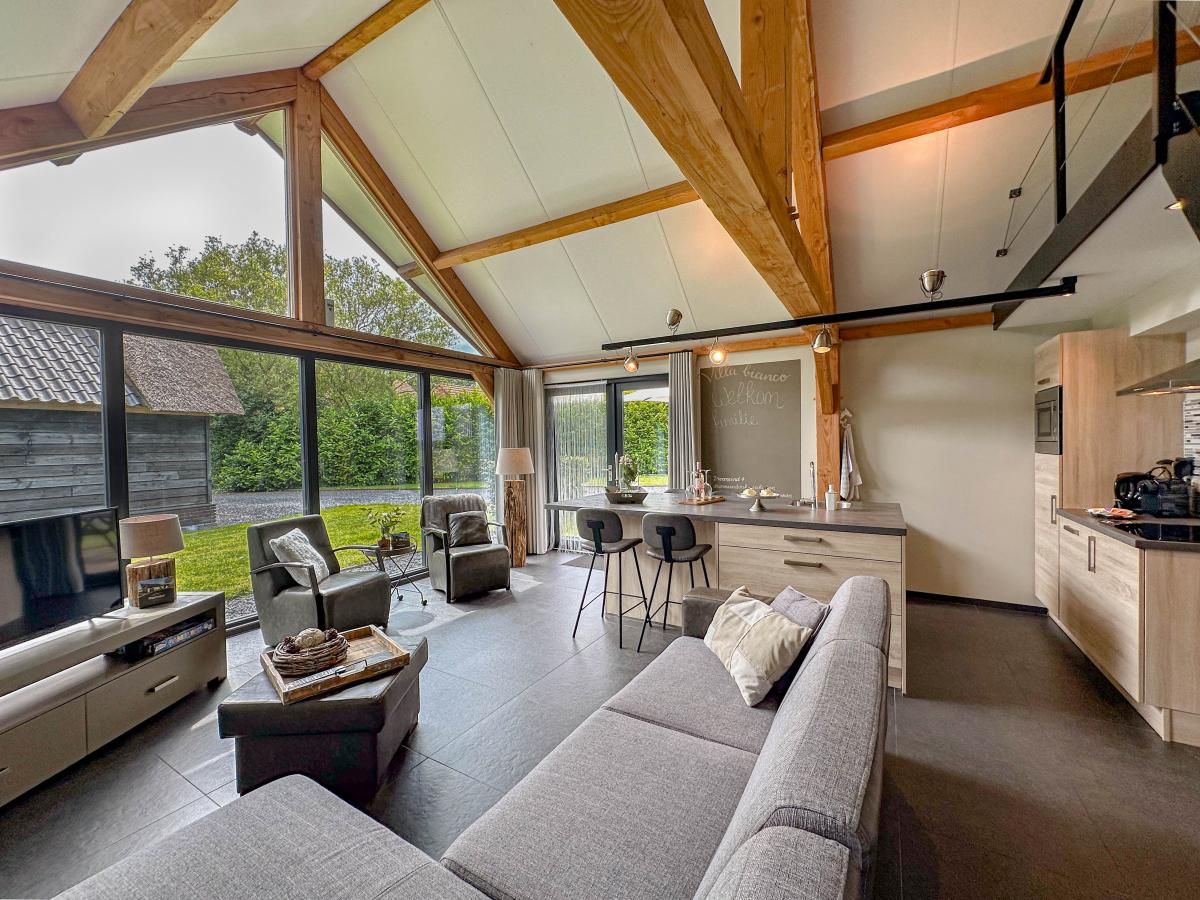 Modern living room of Villa Bianco vacation home in Alphen, North Brabant.