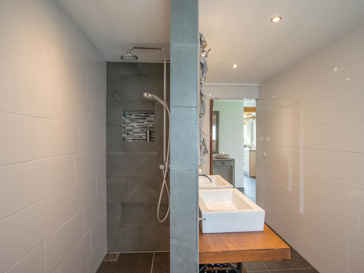 Modern walk-in shower in Villa Bianco vacation home, Alphen, West Brabant.