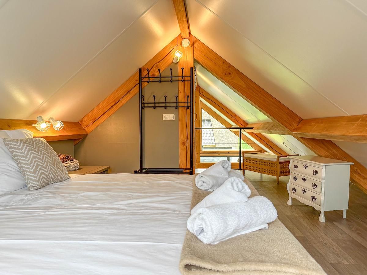 Cozy attic room with wooden beams in Villa Bianco, Alphen.