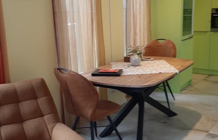 Dining area with wooden table in Holiday home in Werkendam, West Brabant, North Brabant