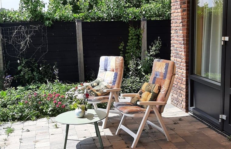 Sunny terrace with chairs in Holiday home in Werkendam, West Brabant, North Brabant