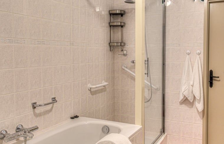 Geraeumiges Schlafzimmer im Huisje in Sprundel, einem Ferienhaus in Nordbrabant mit heller Einrichtung.