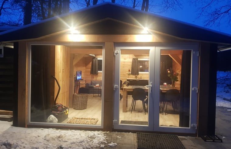 Illuminated evening view of Cottage in Schijf, vacation home in atmospheric North Brabant.
