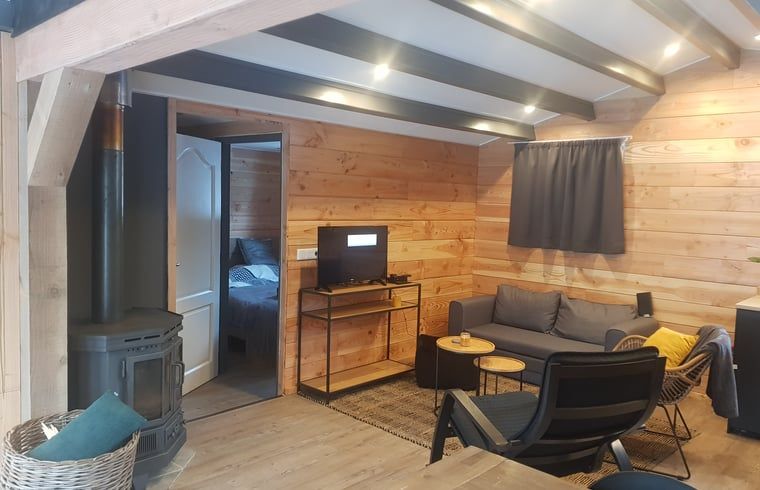 Homey living room in Cottage in Schijf, vacation home in North Brabant with wood stove.