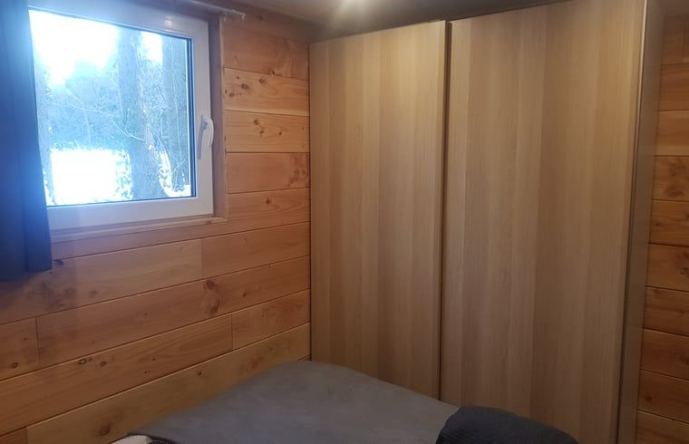 Bedroom with wood finish in Cottage in Schijf, vacation home in rustic North Brabant.