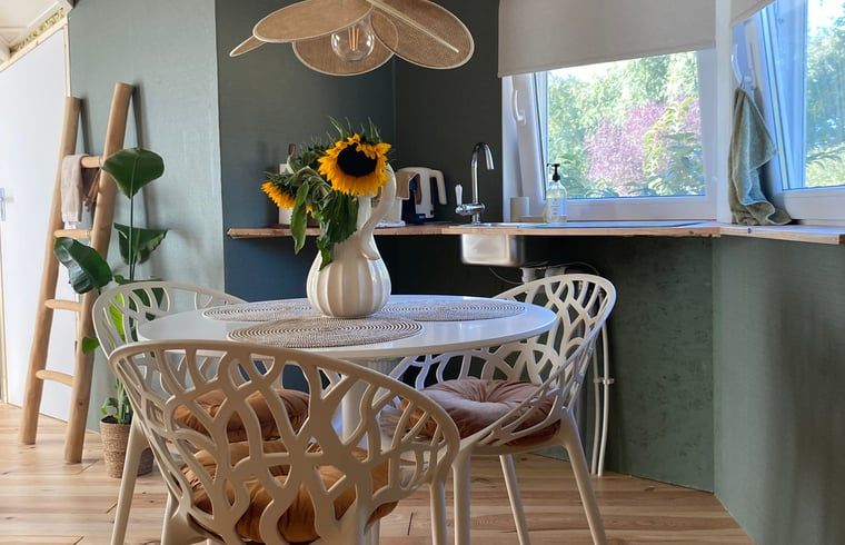 Dining table with sunflowers at Holiday Home in Fijnaart, North Brabant.
