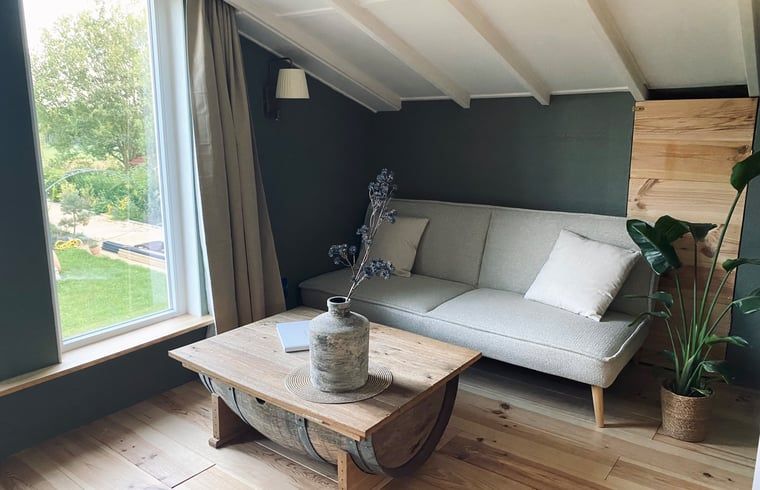 Comfortable sitting area with view in Holiday home in Fijnaart, North Brabant.