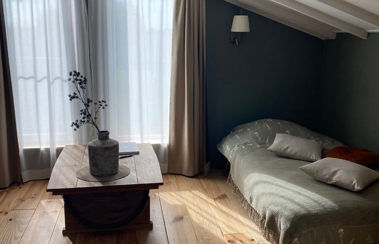 Cozy sleeping area with natural light in Holiday Home in Fijnaart, West Brabant.