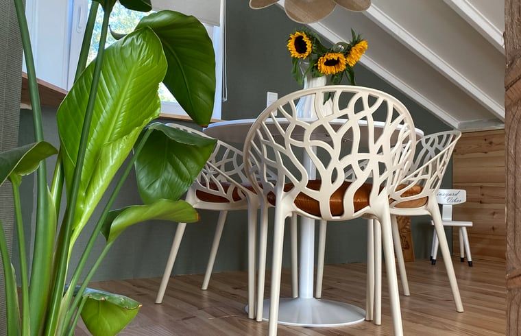 Cozy dining area with plants in Holiday home in Fijnaart, North Brabant.