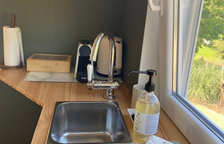 Compact kitchen with a view in Holiday home in Fijnaart, West Brabant.