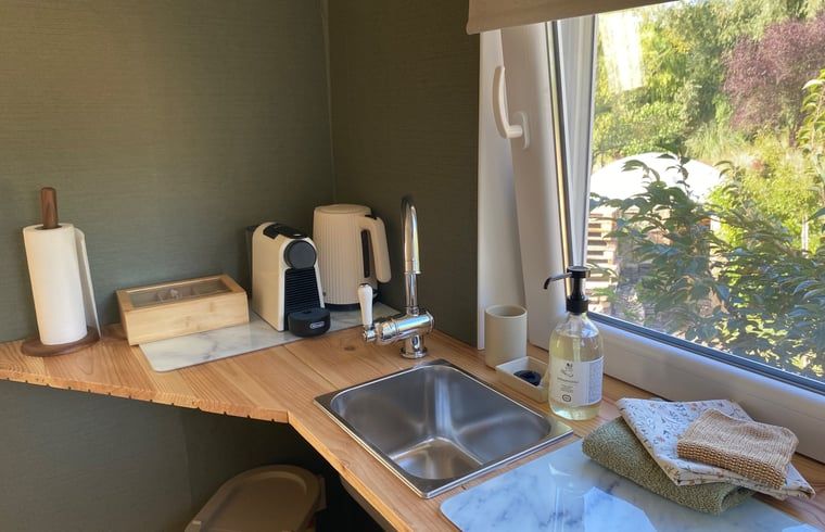 Modern kitchen with coffee maker in Holiday home in Fijnaart, North Brabant.