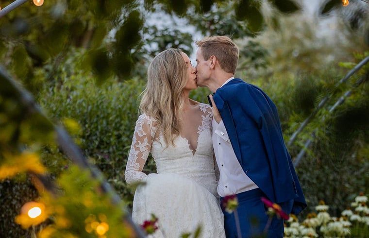 Romantic kiss in the garden of Holiday Home in Fijnaart, West Brabant.
