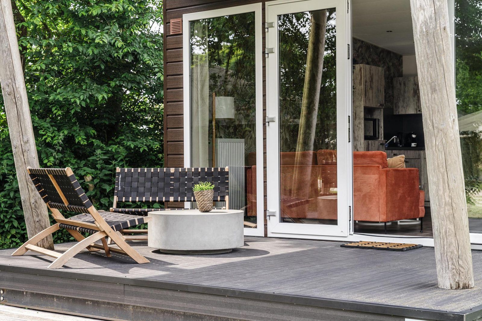 Veranda of Beach House sleeps 6 in Julianadorp, North Holland, with modern seating areas and views of green nature on the North Sea coast.