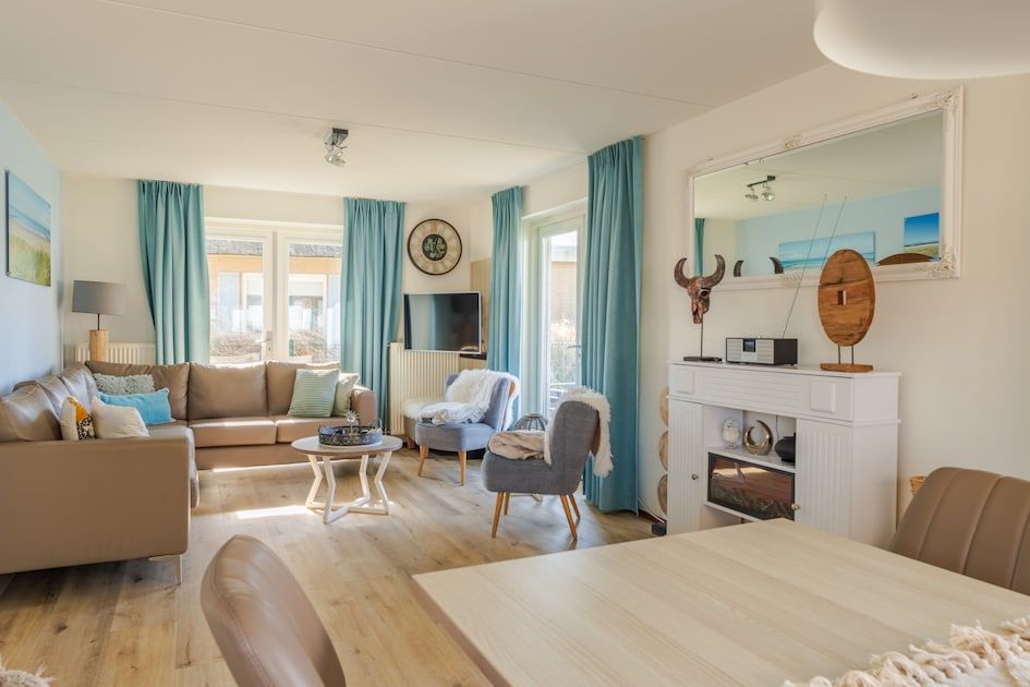 Stijlvolle woonkamer in Villa Luxe 6, een vakantiehuis in Julianadorp aan de Noordzeekust, Noord-Holland, met moderne inrichting en veel licht.
