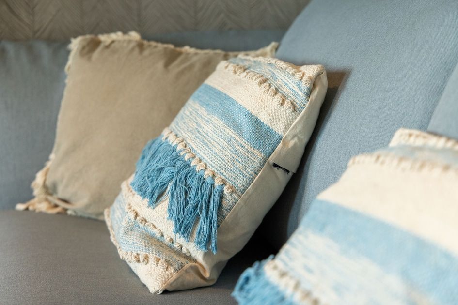 Gemuetliche Sitzecke des Apartments 4B in Egmond aan Zee, Nordseekueste, Nordholland, mit bequemen Kissen auf dem Sofa.