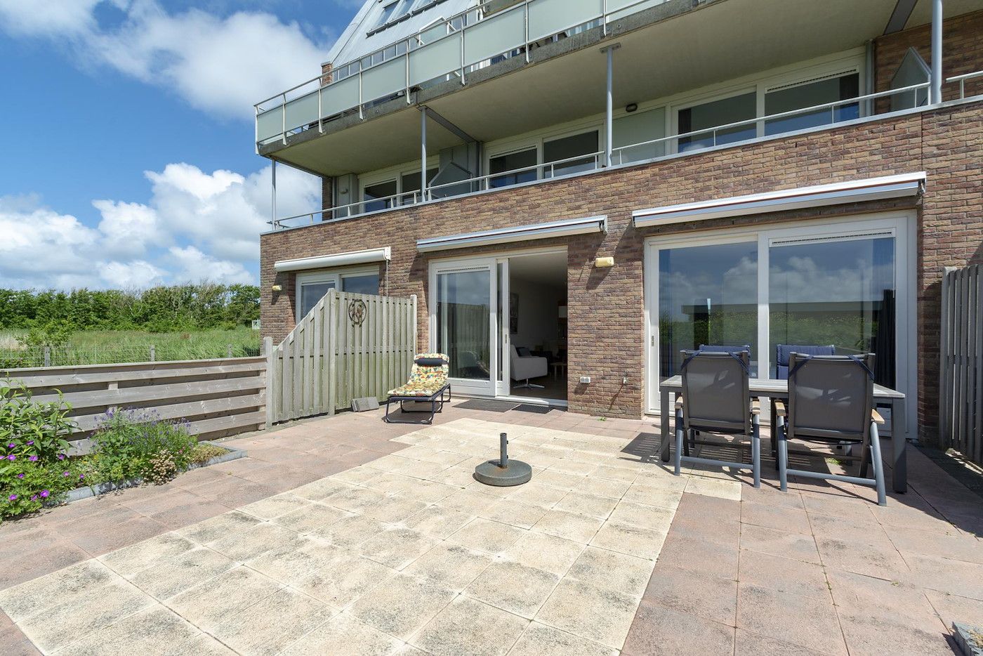 Sunny terrace at Duinerei C002 Groote Keeten vacation home in Callantsoog, North Sea coast, North Holland.