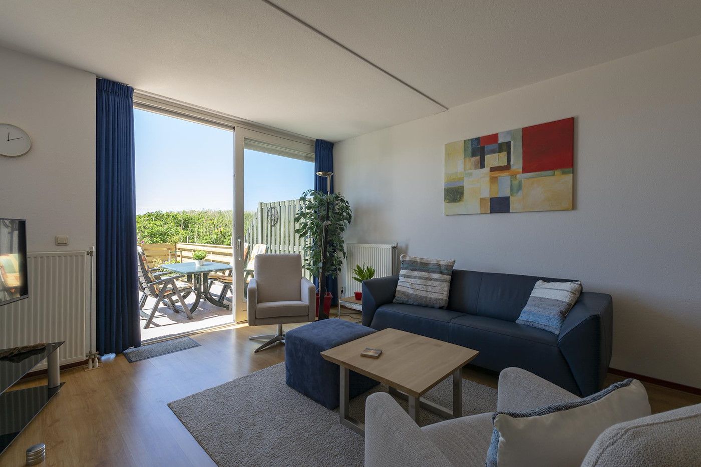 Bright living room with terrace at Duinerei C002 Groote Keeten vacation home in Callantsoog, North Sea coast, North Holland.