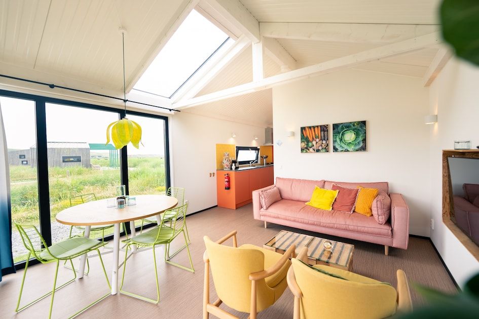 Bright interior space of Callants Comfort 4 in Callantsoog, with cozy sitting area and dining area.