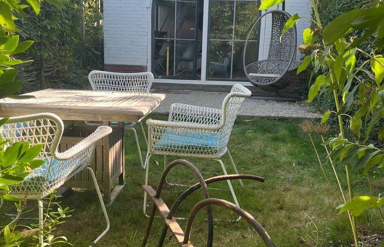 Rustige tuin met zitje bij Vakantiehuis in Groet, Noordzeekust, Noord-Holland