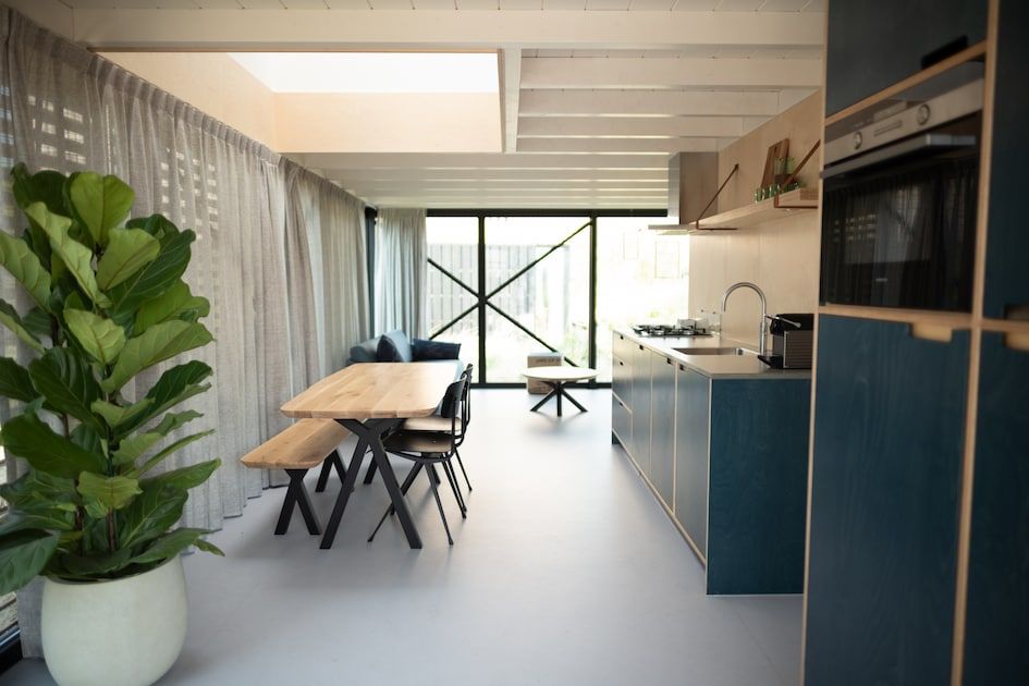 Modern interior of vacation home Royal Amsterdam 4 XL in Zandvoort, North Sea coast, with stylish kitchen and dining area.