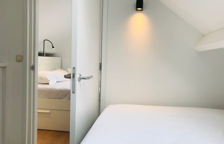 Bright bedroom in Holiday Home in Andijk with comfortable beds, perfect for a relaxing stay.