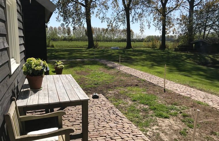 Sunny terrace at Holiday Home in Andijk, ideal for outdoor relaxation.