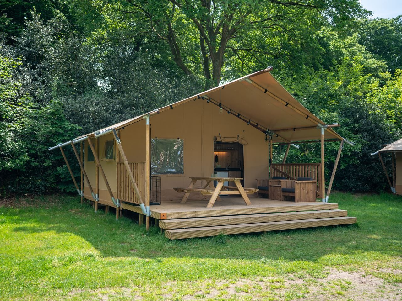 Gemuetliches Interieur des Safarizeltes 2-4ST in Huizen mit Holzkueche und Essbereich, ideal fuer Glamping an der IJsselmeerkueste.