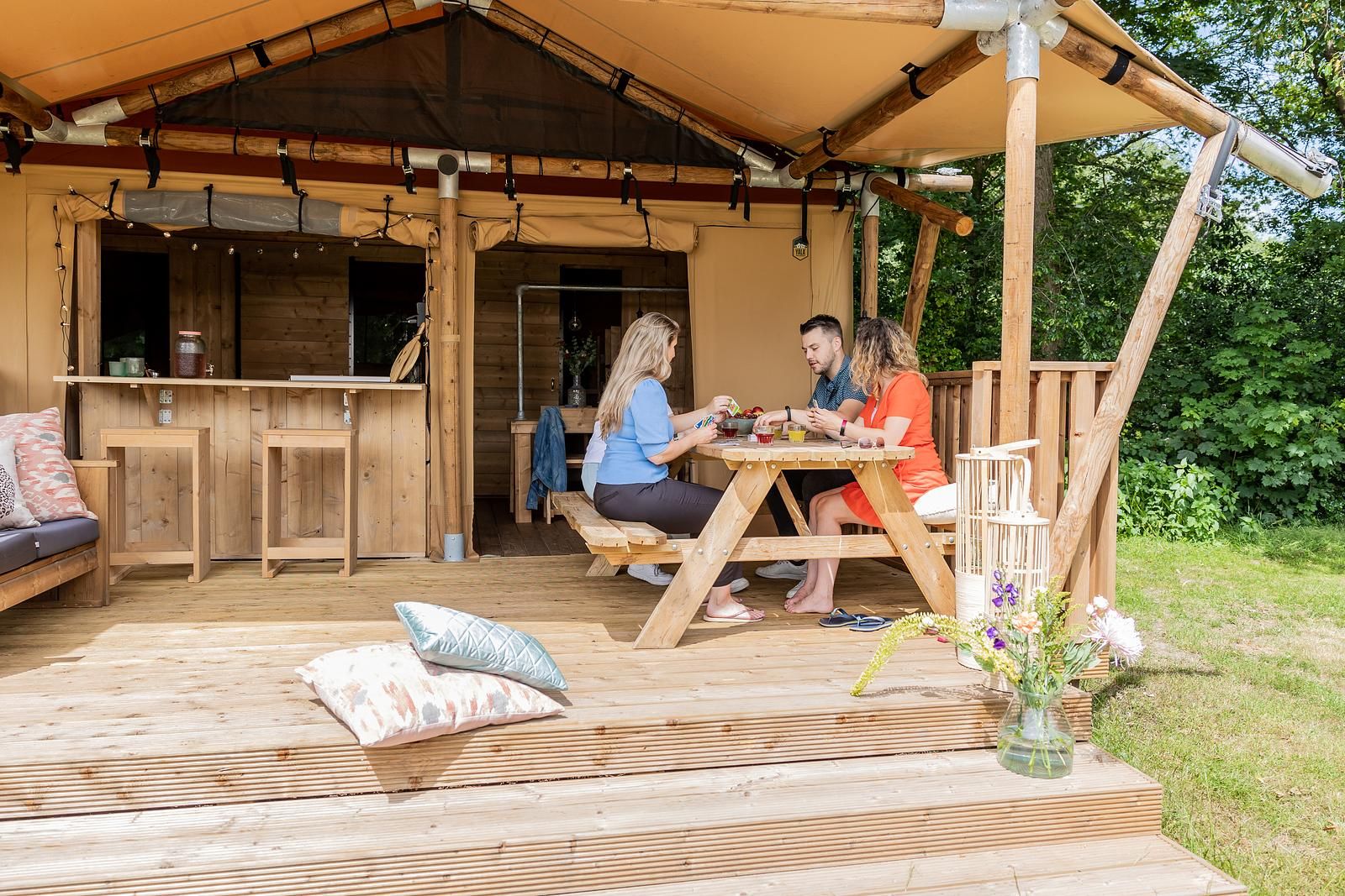 Enjoy a relaxing meal on the terrace of De Heide Tent, an atmospheric safari tent in Huizen, IJsselmeer coast, North Holland.