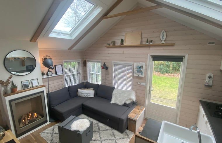 Cozy living room in a cottage in Schoorl, North Holland. Vacation home with bright interior and modern furnishings surrounded by nature.