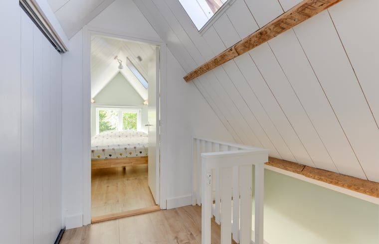 Treppe zum Obergeschoss im Ferienhaus in Schoorl, Nordholland Nord, Nordholland, mit Blick auf das Schlafzimmer.