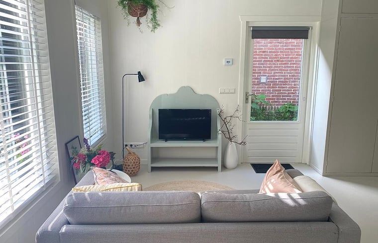 Bright interior of Holiday Home in Driehuizen with modern furnishings and access to garden, North Holland.