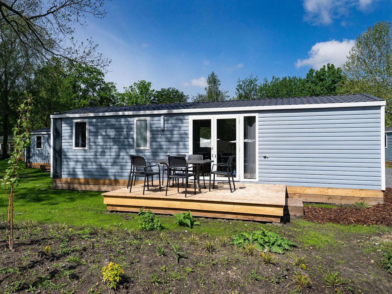 Enjoy the serene veranda of vacation home Berkel 7 in Amstelveen, Amsterdam eo, North Holland, surrounded by green nature.