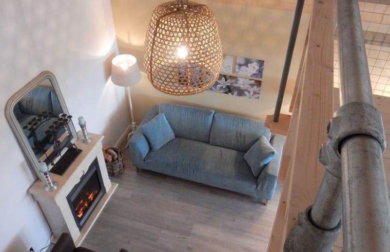 Cozy living room of Holiday home in Weesp, Amsterdam e.o., North Holland with cozy fireplace and comfortable sofa.