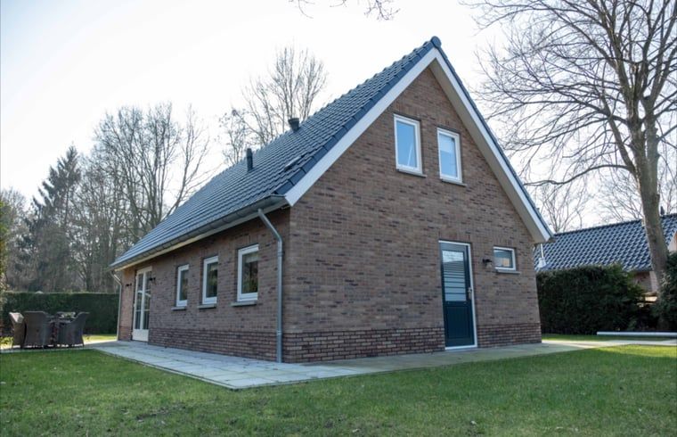 Achterzijde van Vakantiehuisje in Den Ham, Twente, met groene omgeving en moderne architectuur.