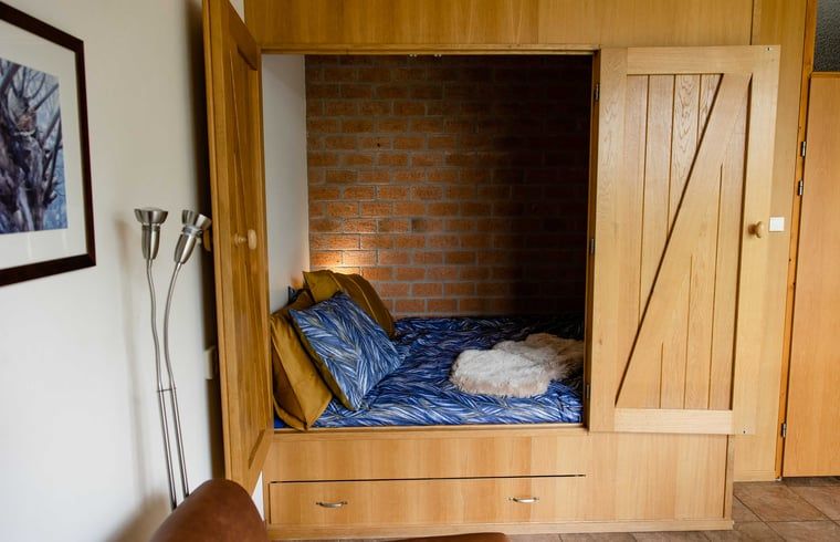 Cozy bedstead in Cottage in Den Ham, vacation home in Twente, Overijssel, with wooden finish and comfortable bed.